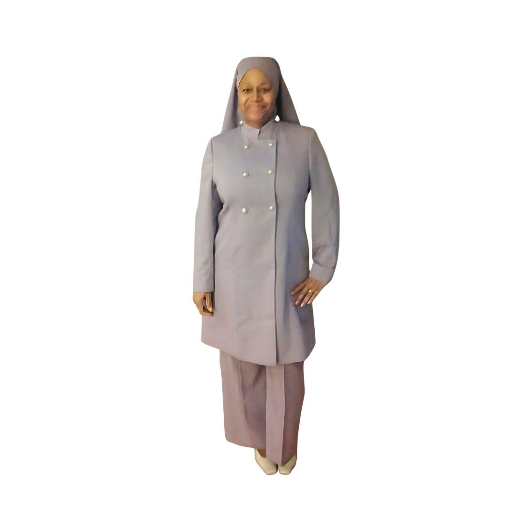 A woman wearing a gray three-piece 'Queen' garment from Kameelah's Closet, showcasing women's modest clothing inspired by the Nation of Islam.