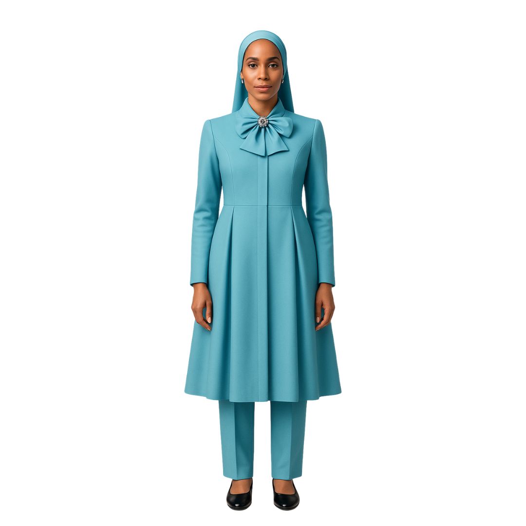 A woman wearing a teal blue traditional and modest long dress with a hand-tied bow, designed for the Nation of Islam community.