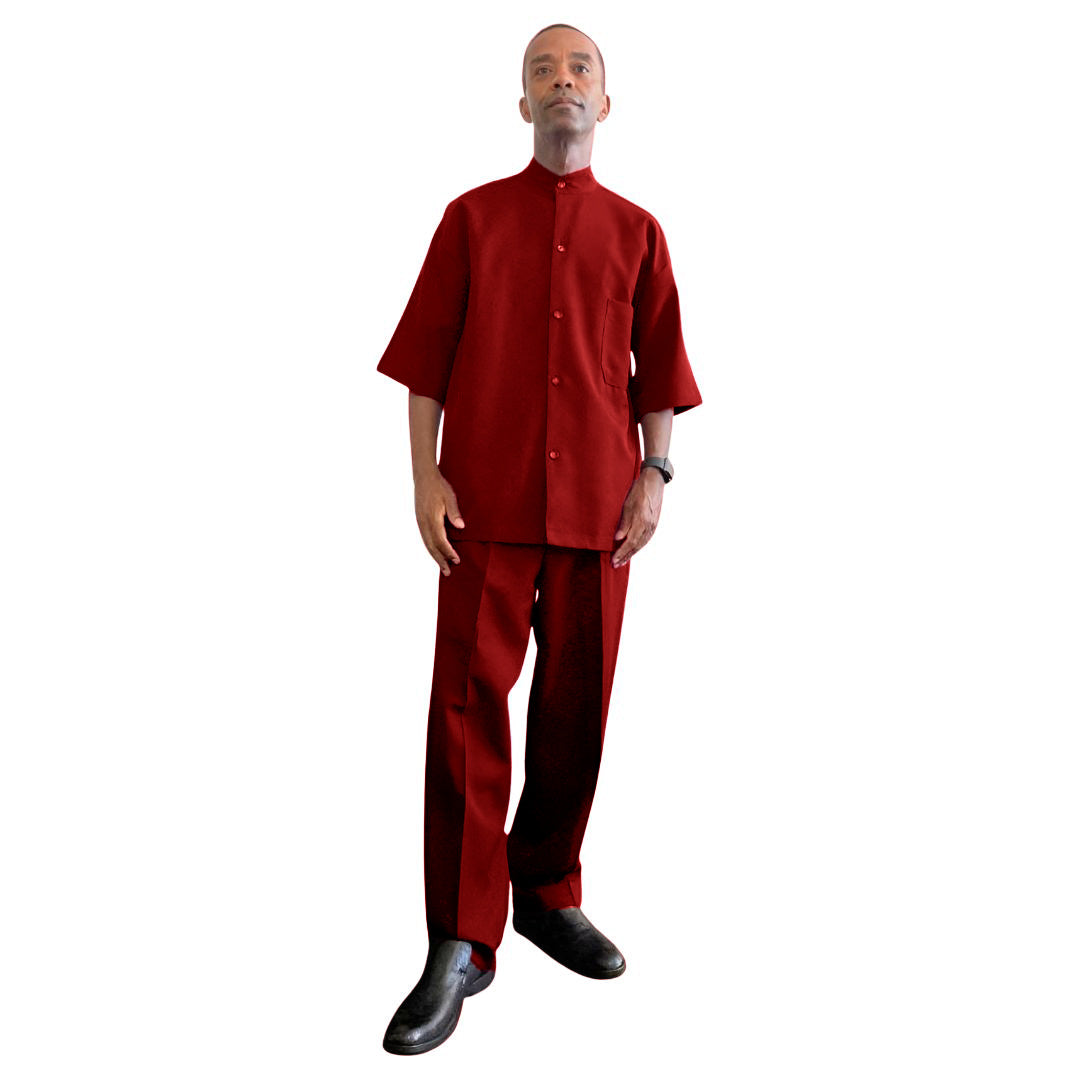 Aleem wearing a crimson embrace modest leisure suit from Kameelah's Closet, designed for members of the Nation of Islam, captured in a striking low-angle shot.