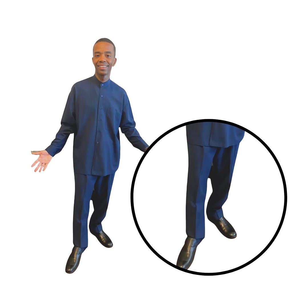 Zoomed-in view of Aleem’s legs, highlighting the slacks of his navy blue leisure suit from Kameelah's Closet, representing modest clothing for Nation of Islam members.