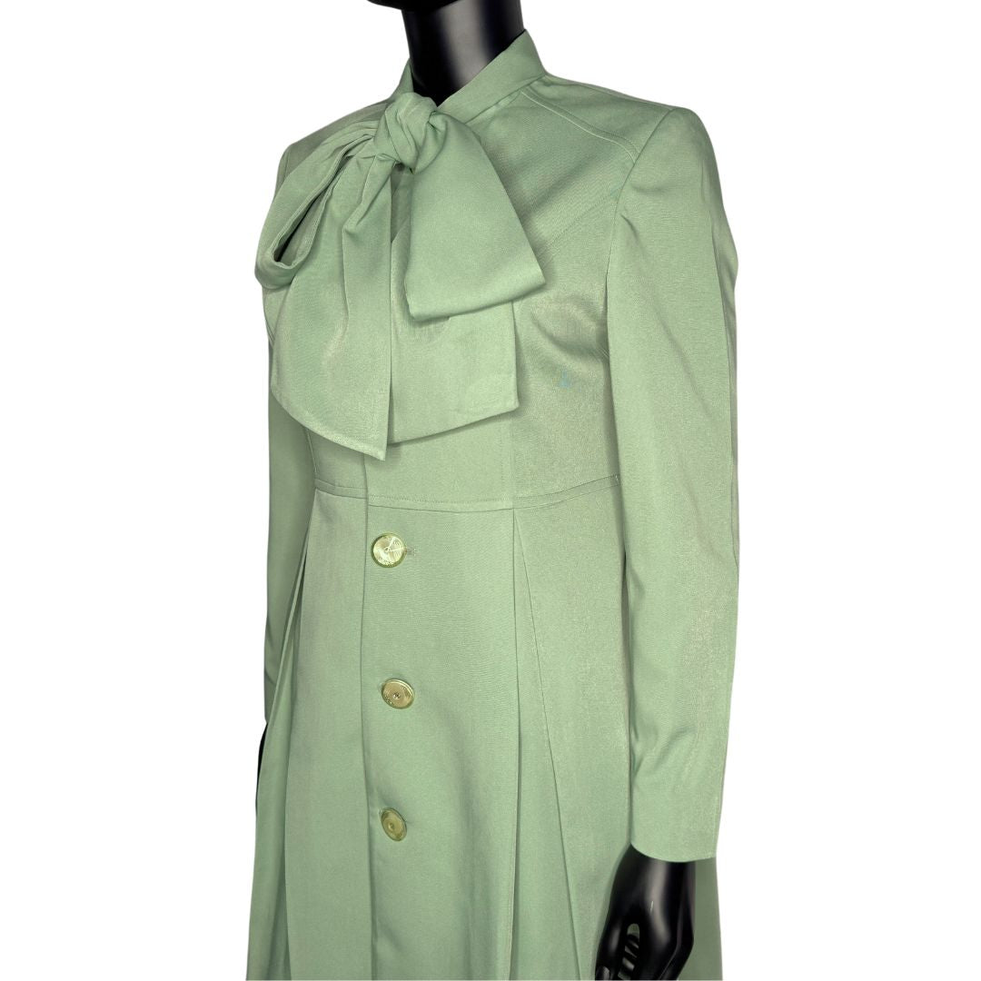 Tilted upper front view 2 of the Sadiyah Bow three-piece sage green garment on a mannequin, designed for Muslim sisters in the Nation of Islam who value women's modest clothing.