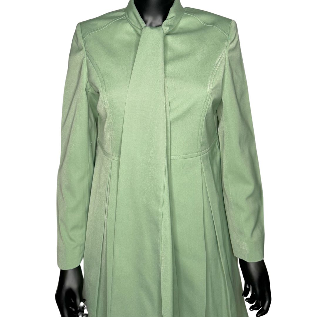 Upper body front view of the Sadiyah Bow three-piece sage green garment on a mannequin, designed for Muslim sisters in the Nation of Islam who value women's modest clothing.