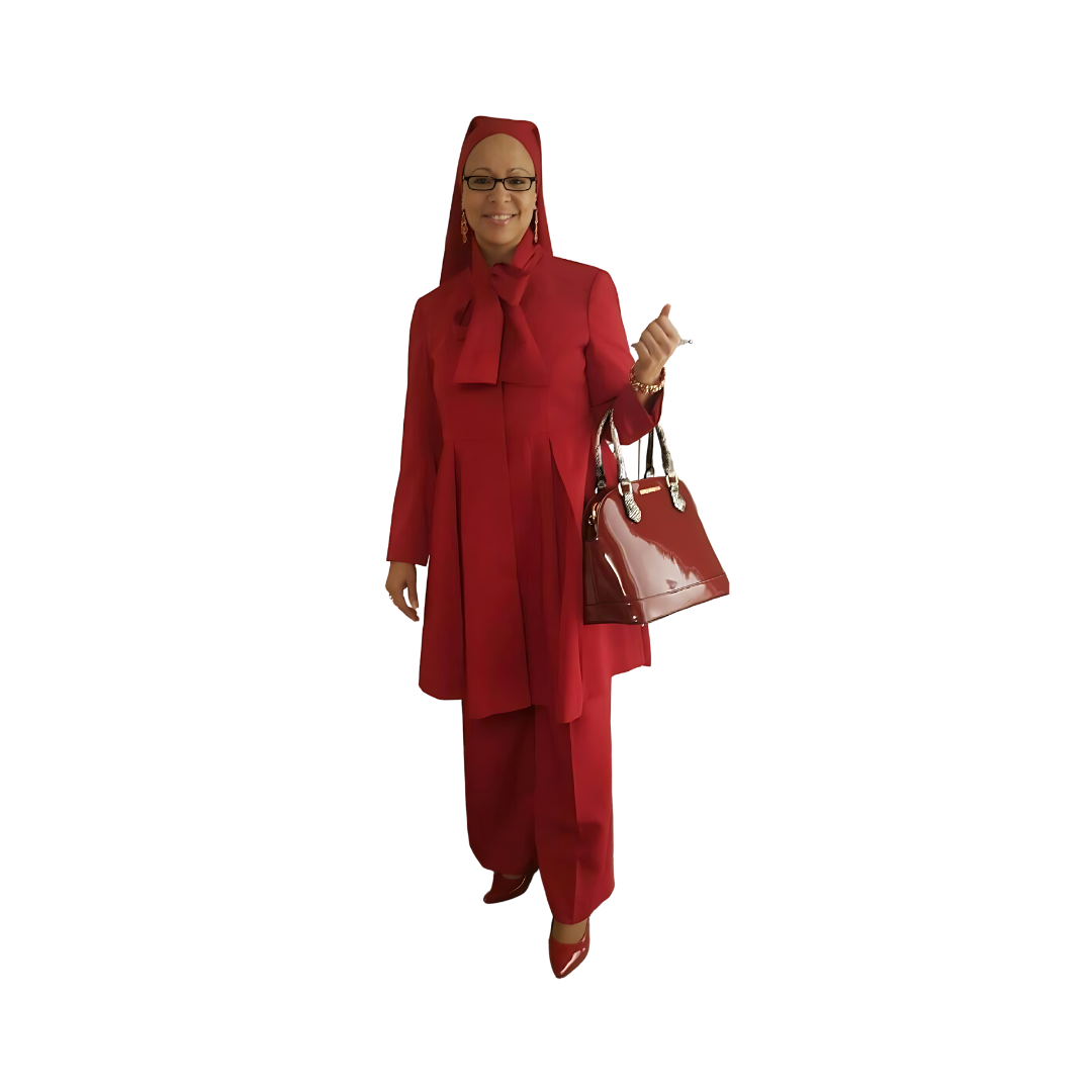 Full-body view of a woman modeling the Sadiyah Bow three-piece red garment from a tilted front and side angle, designed for Muslim sisters in the Nation of Islam who value women's modest clothing.